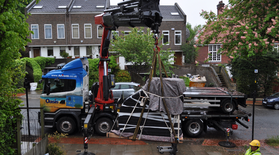 baby grand piano lifted from balcony